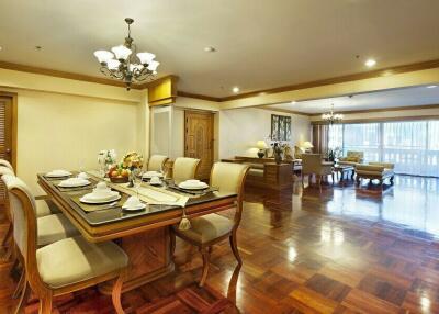 Spacious and elegantly decorated living and dining area with wooden flooring