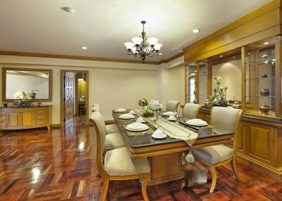 Elegant dining room with polished hardwood floors and detailed woodwork