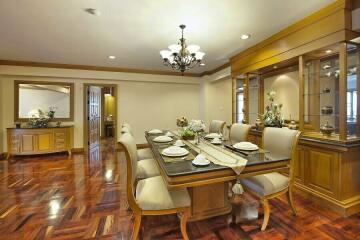 Elegant dining room with polished hardwood floors and detailed woodwork