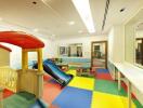 Children's indoor playroom with colorful mats and play equipment