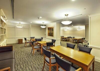 Spacious Common Room with Tables, Chairs and Pendant Lighting