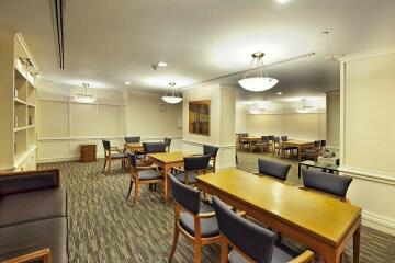 Spacious Common Room with Tables, Chairs and Pendant Lighting