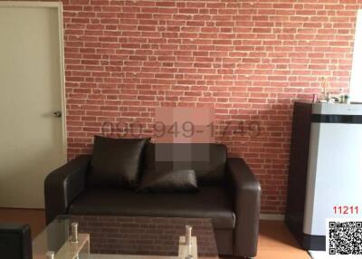 Cozy living room with exposed brick wall and comfortable couch