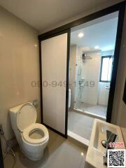 Modern bathroom with glass shower enclosure and white fixtures