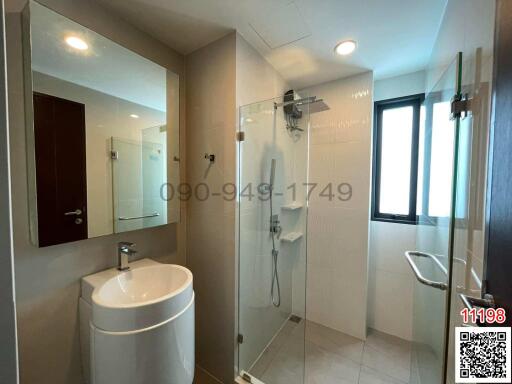 Modern bathroom interior with glass shower and vanity