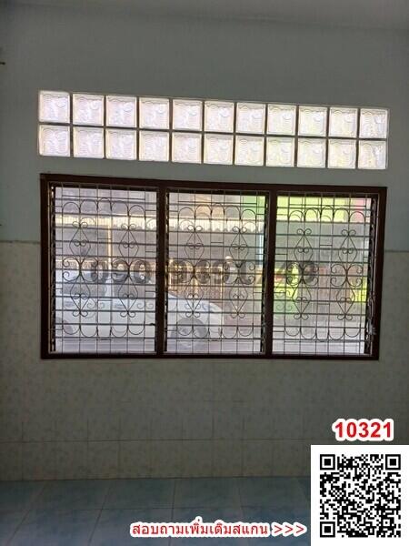 Spacious room with large window and iron security bars