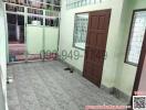 Tiled residential entryway with brown door and security gate