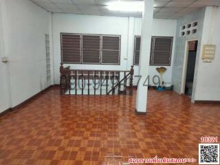 Spacious living area with tiled floors and multiple windows