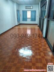 Spacious living room with tiled flooring and natural light