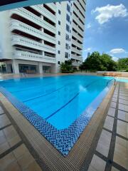 Swimming pool with clear blue water adjacent to a modern residential building