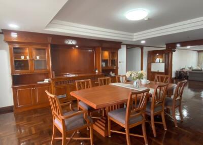 Spacious dining area with wooden furniture and ambient lighting