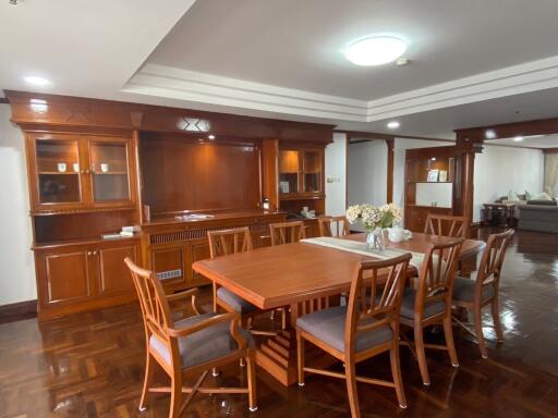 Spacious dining area with wooden furniture and ambient lighting