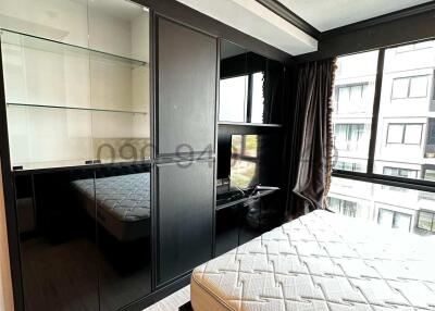 Modern bedroom with large bed and mirrored wardrobe
