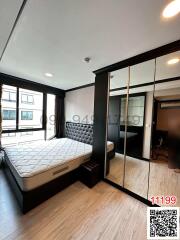 Modern bedroom with large bed and mirrored wardrobe