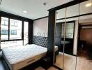 Modern bedroom with large bed and mirrored wardrobe