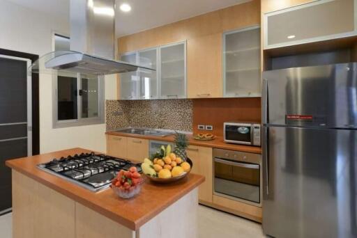 Modern kitchen with stainless steel appliances and wooden cabinets