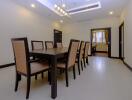 Spacious dining room with large table and rattan chairs