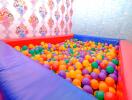 Colorful ball pit in a children's playroom with vibrant walls