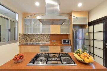 Modern kitchen with stainless steel appliances and stone countertop