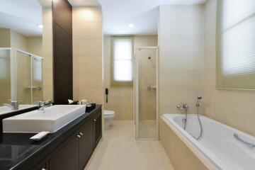 Spacious modern bathroom with a bathtub and a glass-enclosed shower