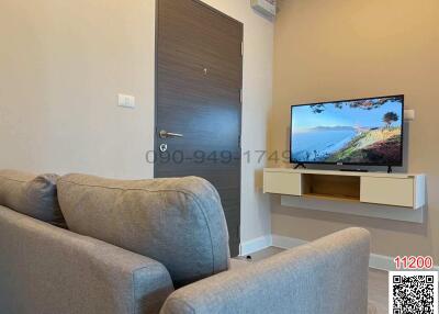 Cozy living room with modern furniture and television set