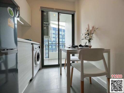 Modern kitchen with dining area and balcony access in an apartment