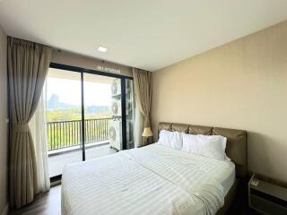 Modern bedroom with large windows and city view