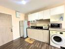 Modern kitchen interior with wooden cabinets and various appliances