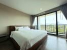 Spacious Bedroom with Large Windows and Scenic View