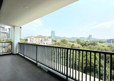 Spacious balcony with cityscape view and protective railing