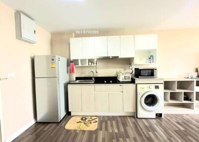 Modern kitchen with appliances and wooden flooring