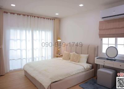 Spacious and well-lit bedroom with double bed and modern amenities