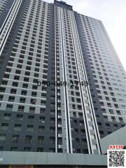 High-rise residential apartment building facade with numerous balconies