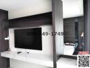 Modern bedroom interior with wall-mounted TV and built-in cabinets