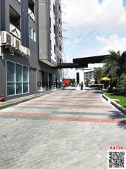 Modern residential building exterior with paved entrance driveway