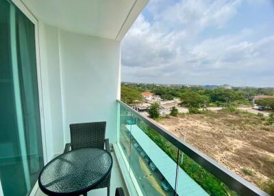 Spacious balcony with outdoor seating and scenic view