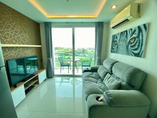 Modern living room with balcony access and natural lighting