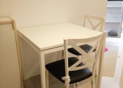 Compact dining table with chairs in a small dining area