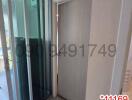Hallway leading to sliding glass door with QR code and watermark