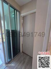 Hallway leading to sliding glass door with QR code and watermark