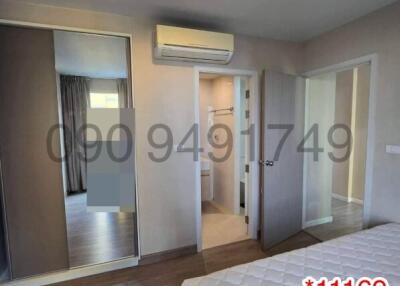 Modern bedroom interior with large mirror wardrobe and air conditioning