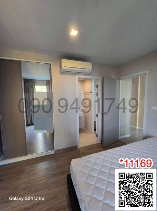 Modern bedroom interior with large mirror wardrobe and air conditioning