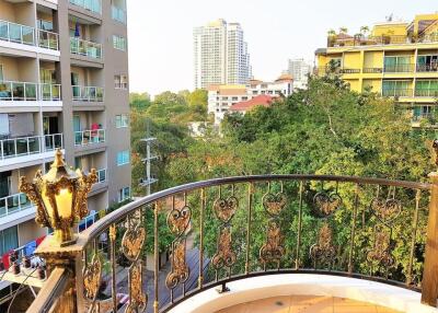 Balcony with ornate railing overlooking city landscape