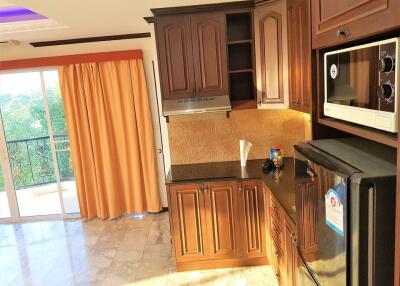 Modern kitchen with wooden cabinets and stainless steel appliances