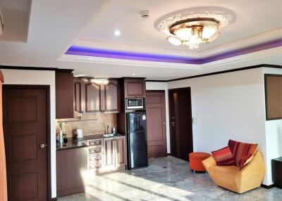 Modern kitchen with LED ceiling lighting and adjacent sitting area