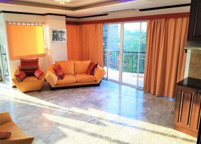 Spacious living room with natural light and balcony access