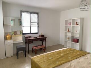 Cozy bedroom with work desk and built-in shelving