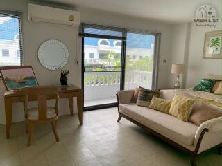 Bright and cozy living room with modern furnishings and balcony access