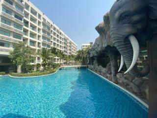 Residential complex with an outdoor swimming pool featuring a large elephant sculpture
