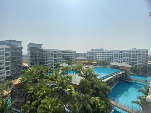 Spacious outdoor pool area surrounded by residential buildings